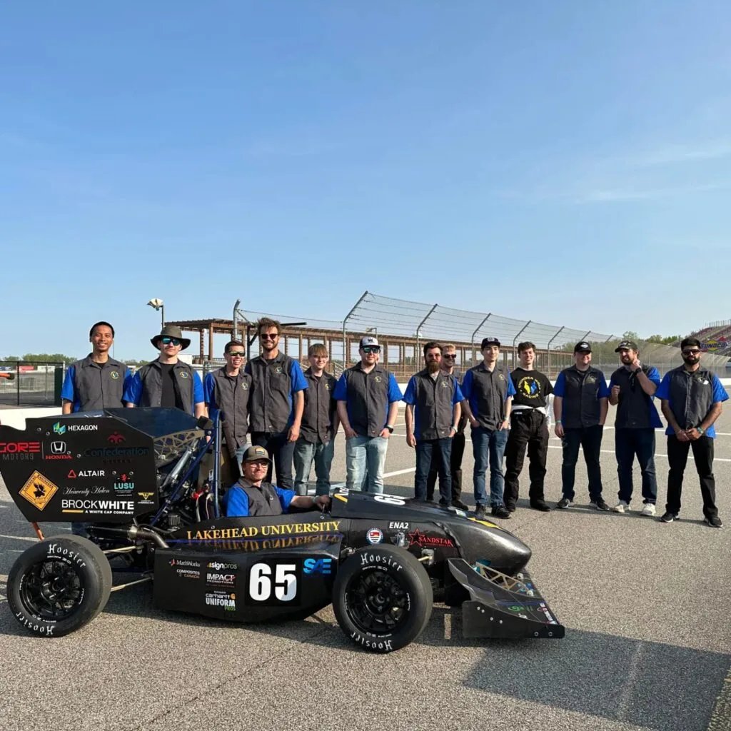 team at competition with car